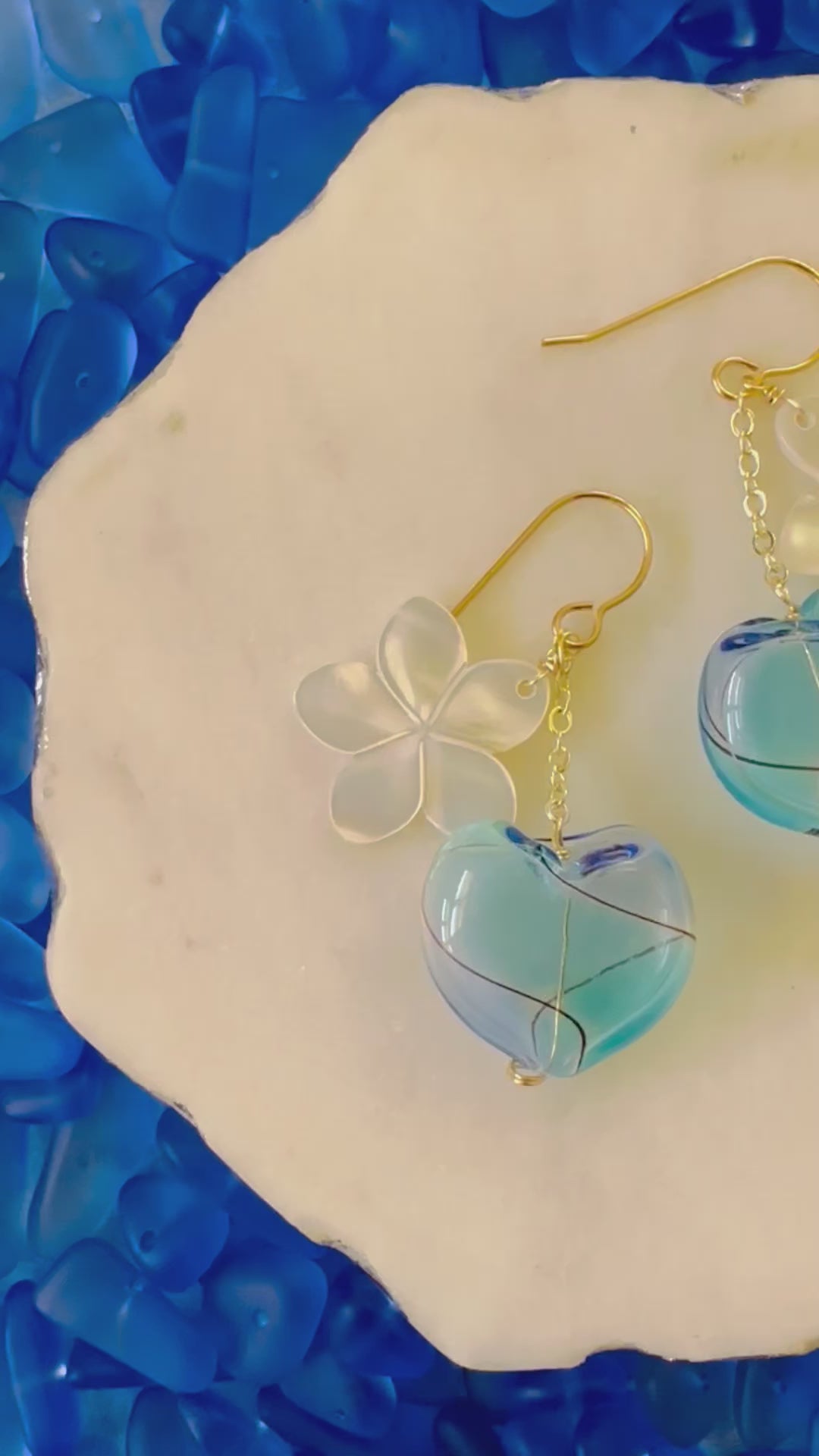 Load video: Plumeria Shell & Blue Heart Earrings
