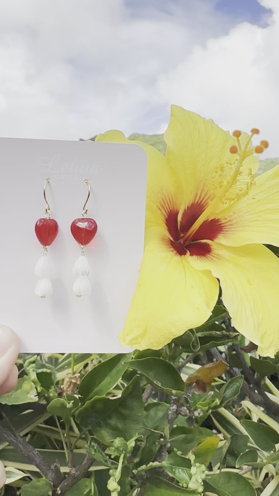Load video: Red Glass Heart &amp; Pikake Flower Earrings